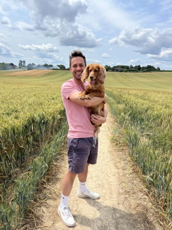 Nick Summerfield with his dog in a field 